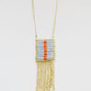 long gold tone necklace with a square of light blue and orange glass beads