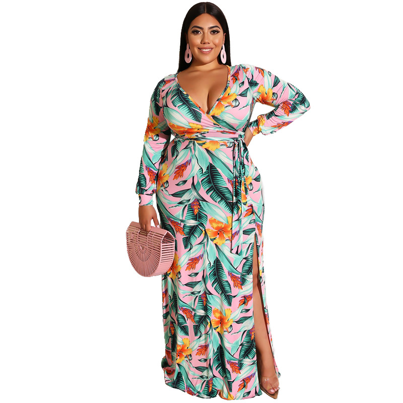 Model wearing a long-sleeved pink floral maxi dress with side slit.